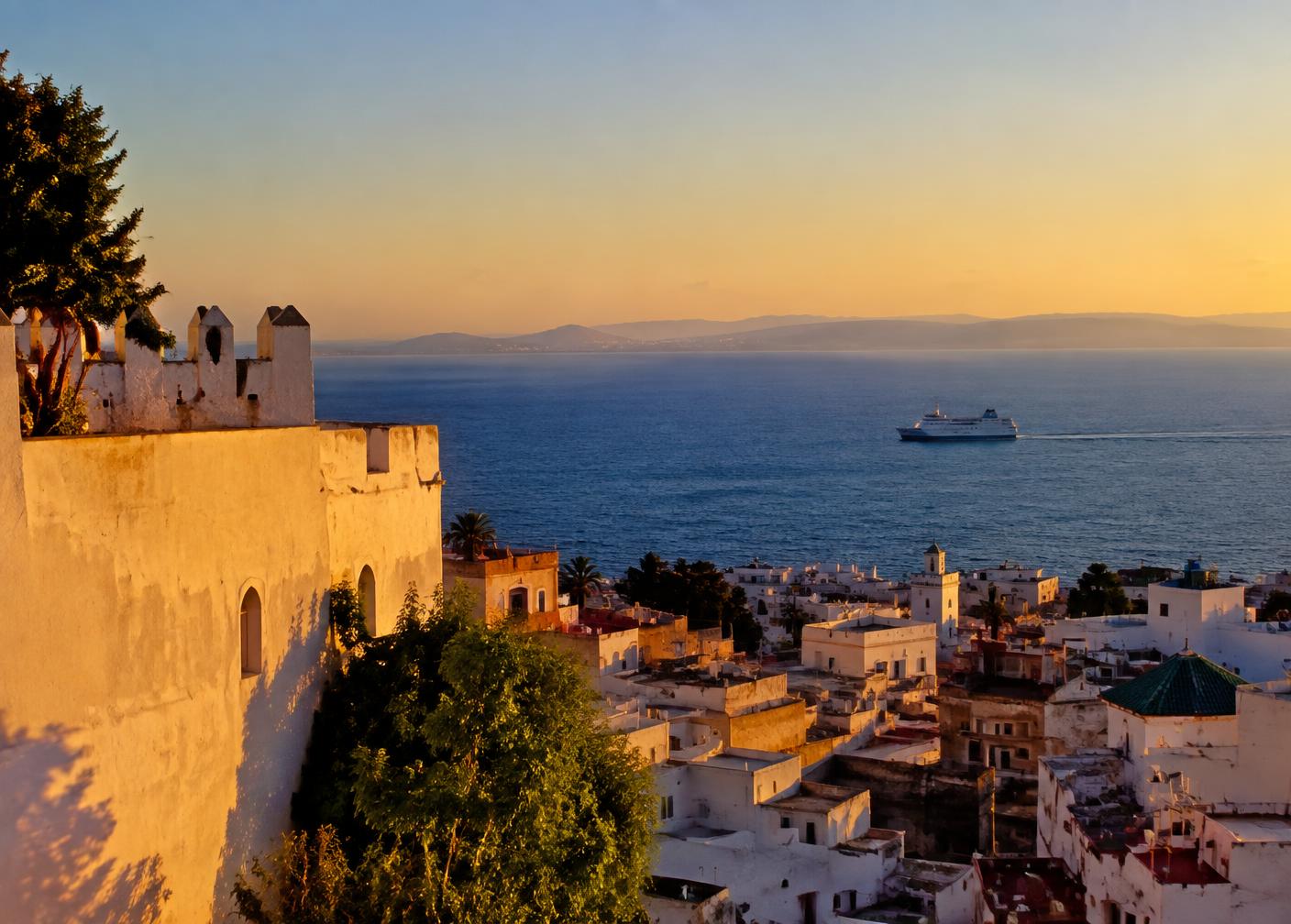 Whitewashed Kasbah walls in Tangier above the Strait of Gibraltar at golden hour
